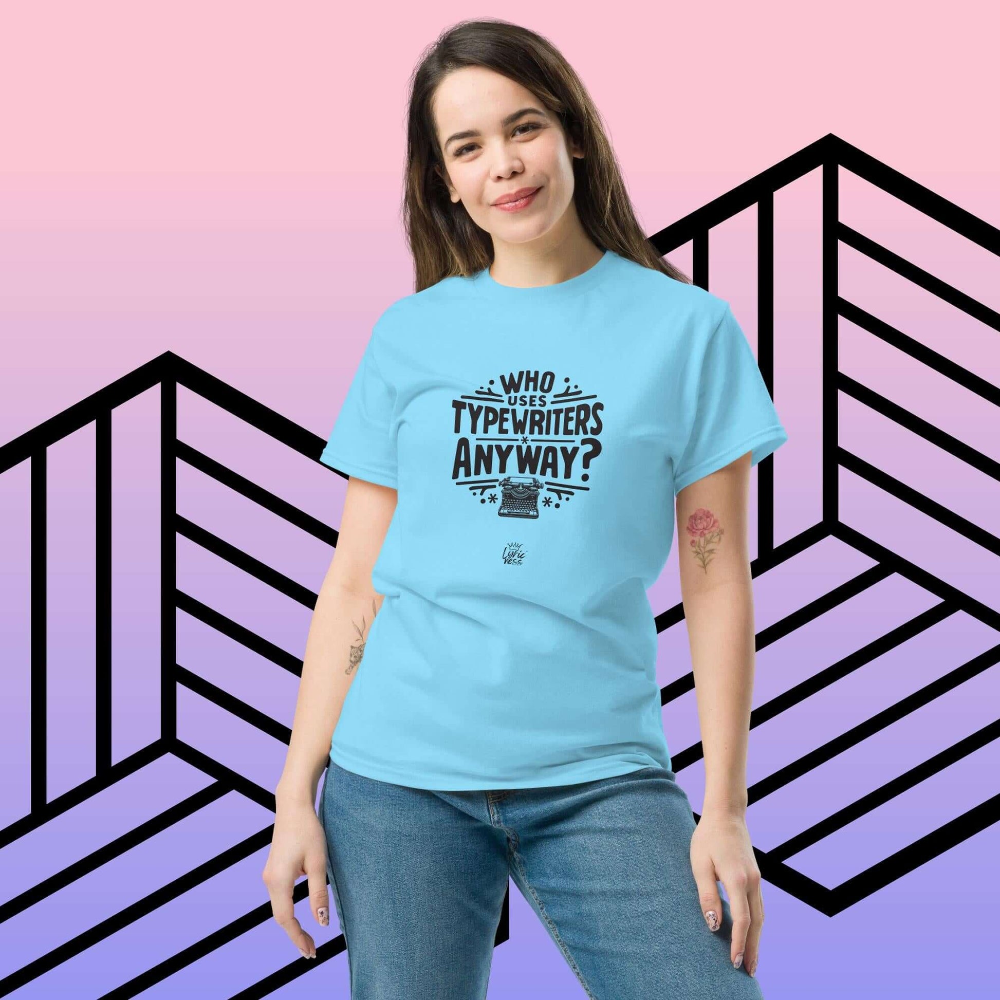 Woman wearing blue "Who Uses Typewriters Anyway?" short-sleeve unisex t-shirt against a geometric background